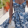 Blue floral off-shoulder mini dress by FJØRNA, elegant party wear with a vibrant floral pattern and stylish off-shoulder design.