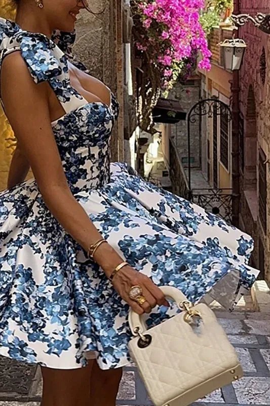 Blue floral off-shoulder mini dress by FJØRNA, elegant party wear with vibrant floral pattern and stylish fit.