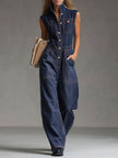 Dark blue denim FJØRNA jumpsuit with multi-pocket design, sleeveless balloon silhouette, and casual style.