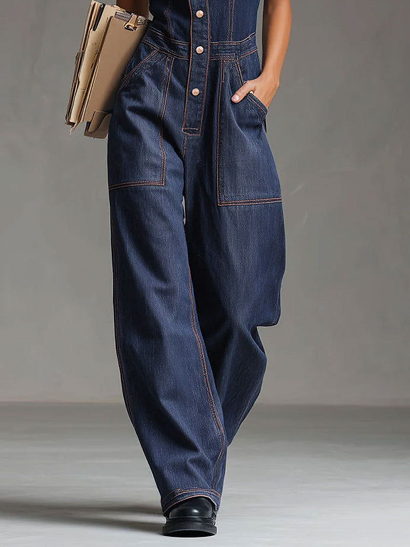Dark blue denim FJØRNA sleeveless balloon jumpsuit with multiple pockets and a relaxed fit.