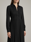 Close-up of FJØRNA women's button front maxi dress showing long sleeves and detailed fabric in a summer dress style.