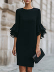 FJØRNA black dress with ruffled sheer sleeves, elegant evening dress with flowing fabric and stylish design.