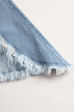 Light blue denim flared jumpsuit with long sleeves and wide-leg design by FJØRNA, shown on a model.