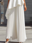 White FJØRNA maxi dress featuring sculpted asymmetric peplum and pleated design, elegant and flowing for women's formal wear.
