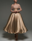 Pink satin midi dress for women by FJØRNA featuring a strapless, A-line silhouette and matching shawl and strappy details.