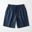 Men's summer linen shorts by FJØRNA, light and breathable fabric, shown in a relaxed fit with casual style.