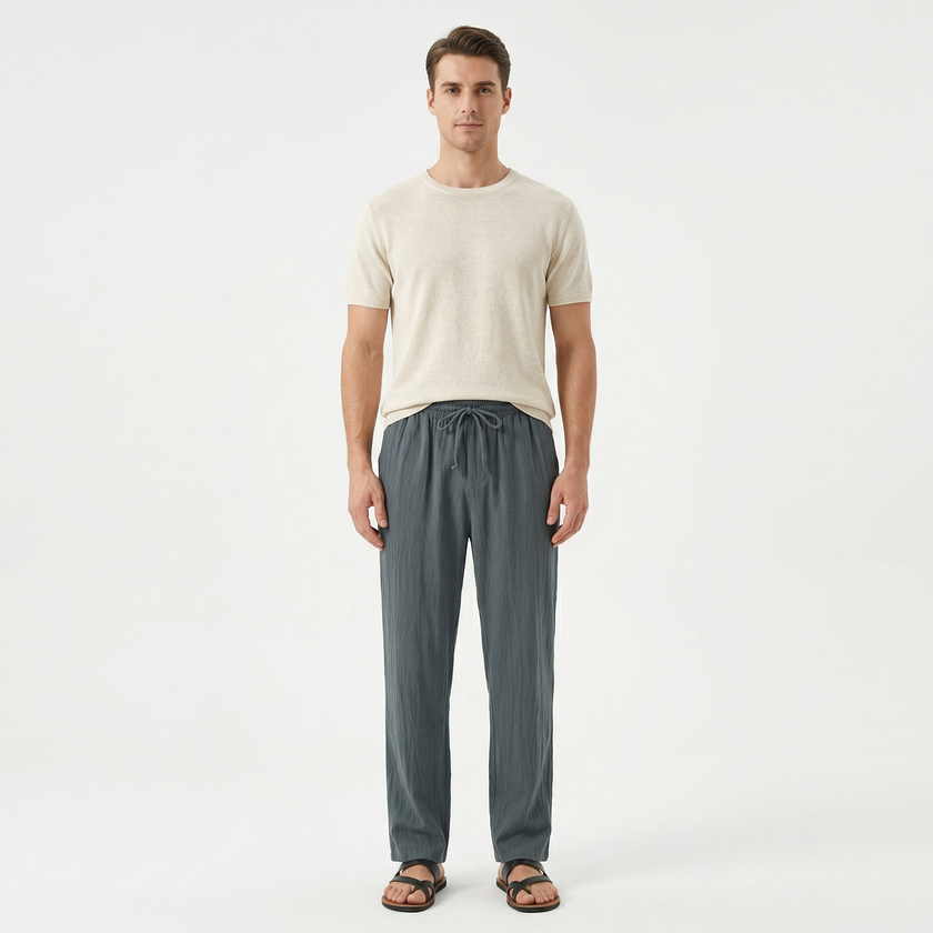 Men's linen drawstring trousers by FJØRNA, featuring a relaxed fit, neutral color, and lightweight breathable fabric.