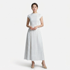 Women's FJØRNA polka dot maxi dress with round neck and A-line silhouette, flowing and stylish for casual or formal wear.