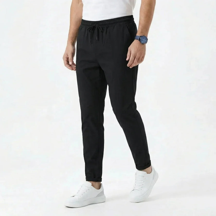 Men's stretchable comfort trousers by FJØRNA, showing a close-up of the black stylish men's pants with a relaxed fit and stretch fabric.