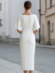 FJØRNA boat neck short sleeve tailored midi dress displayed on a hanger, showcasing its elegant design and smooth fabric.