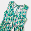 Women's sleeveless floral print boho maxi dress with tie neck details by FJØRNA, shown with flowing fabric and vibrant floral pattern.