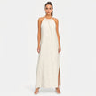 FJØRNA women's sleeveless halter neck summer maxi dress with flowing fabric and vibrant pattern, perfect for warm weather.