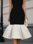 FJØRNA square neck sleeveless midi dress with ruffle hem, showcasing a stylish and elegant dress design.