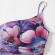 Women's FJØRNA A-line floral maxi dress, flowing fabric with vibrant floral pattern, full-length dress on a model.