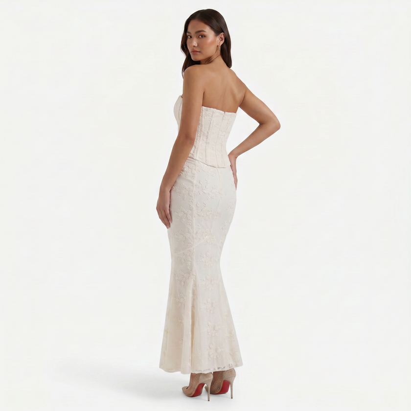 FJØRNA women's strapless lace corset maxi dress featuring a fitted bodice and flowing skirt in elegant lace fabric.