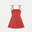 FJØRNA women's floral print tie strap mini dress with vibrant colors and lightweight fabric, displayed on a hanger.