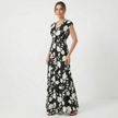 Women's V-neck floral print summer maxi dress by FJØRNA, flowing fabric with colorful floral pattern and V-shaped neckline.