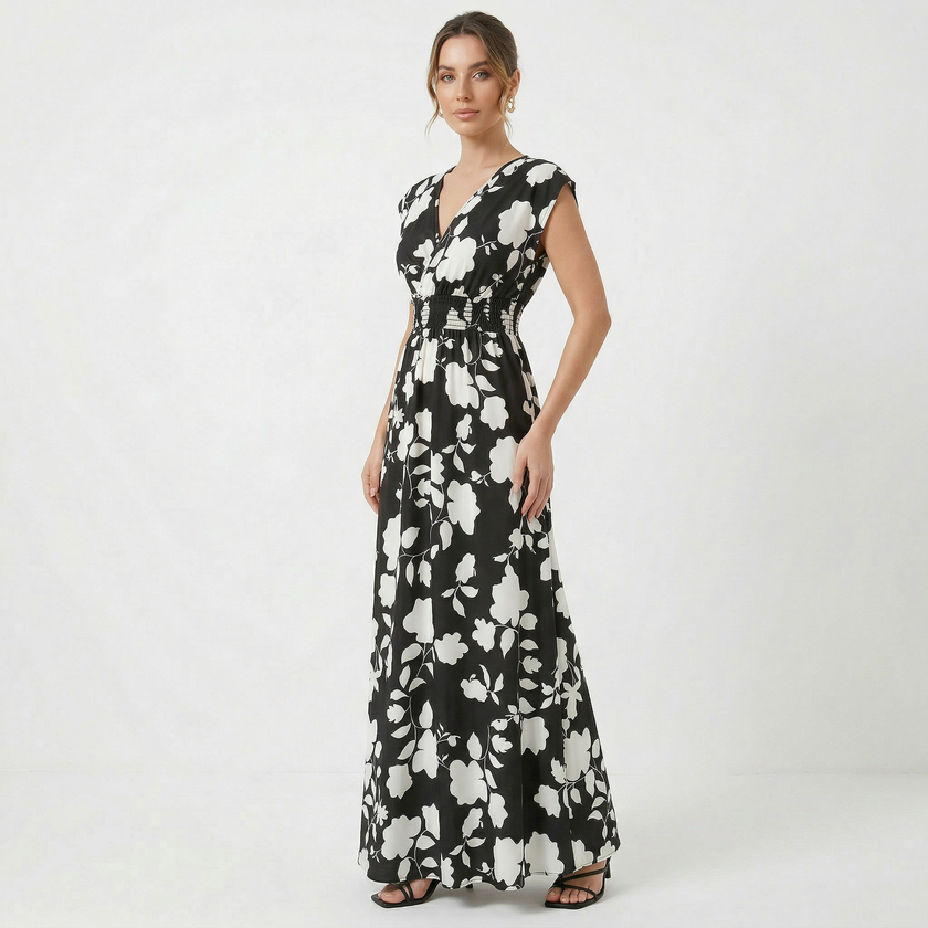 Women's V-neck floral print summer maxi dress by FJØRNA, flowing fabric with colorful floral pattern and V-shaped neckline.