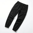 Men's slim fit cotton cargo trousers by FJØRNA, showing the front view with multiple cargo pockets and a tapered leg fit.