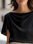 FJØRNA black satin women's blouse with cap sleeves and draped design, stylish top perfect for elegant or casual occasions.