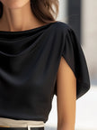 Black satin blouse for women by FJØRNA with cap sleeves and draped design, shown on a model.