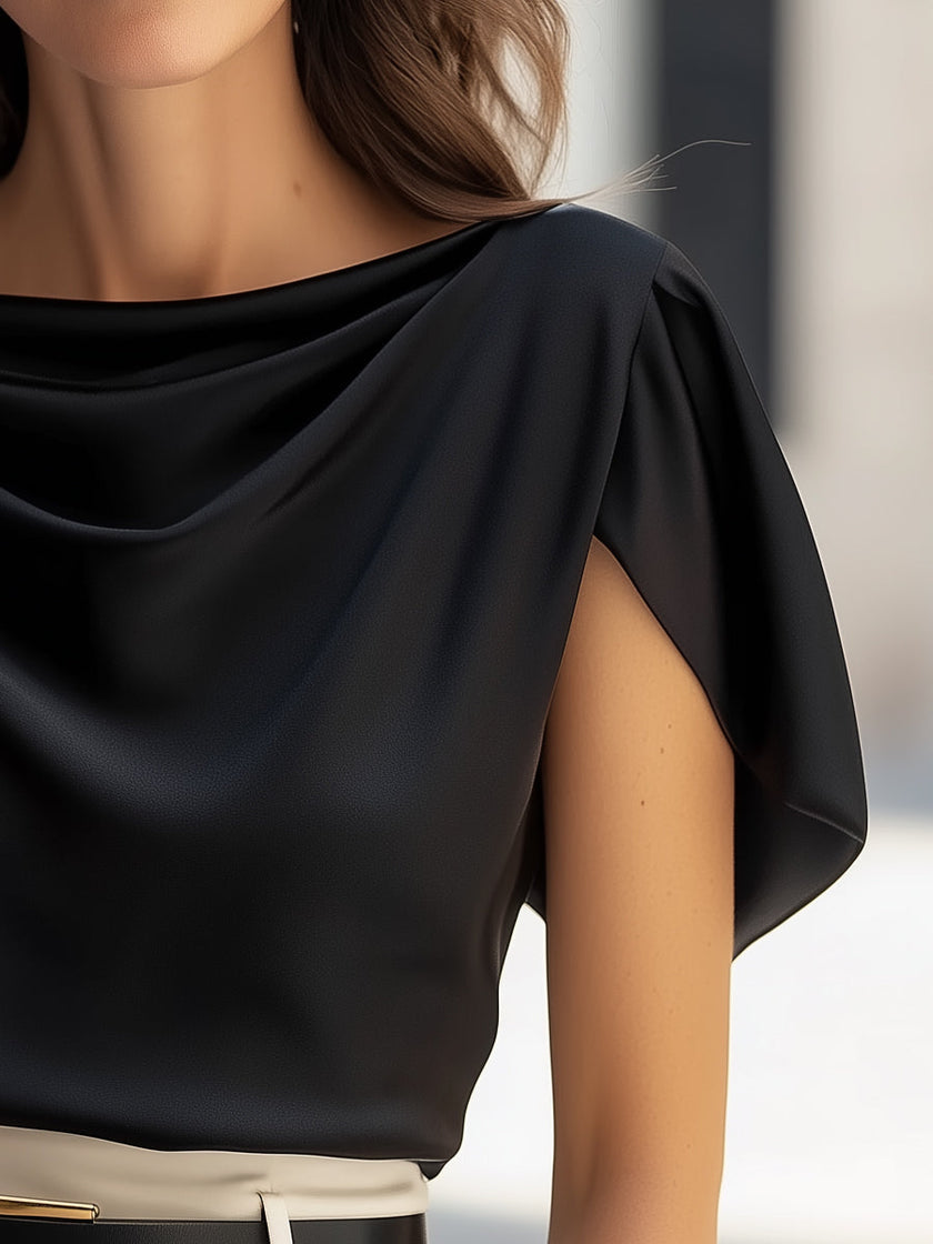 Black satin blouse for women by FJØRNA with cap sleeves and draped design, shown on a model.