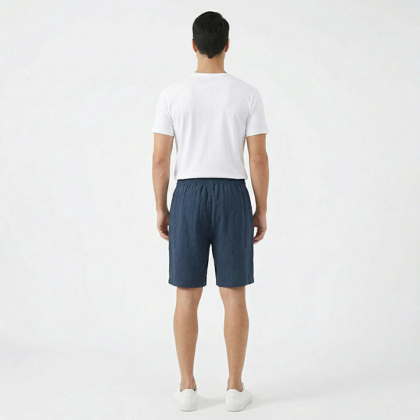 Men's summer linen shorts by FJØRNA, featuring a relaxed fit and light fabric, shown in a neutral color.