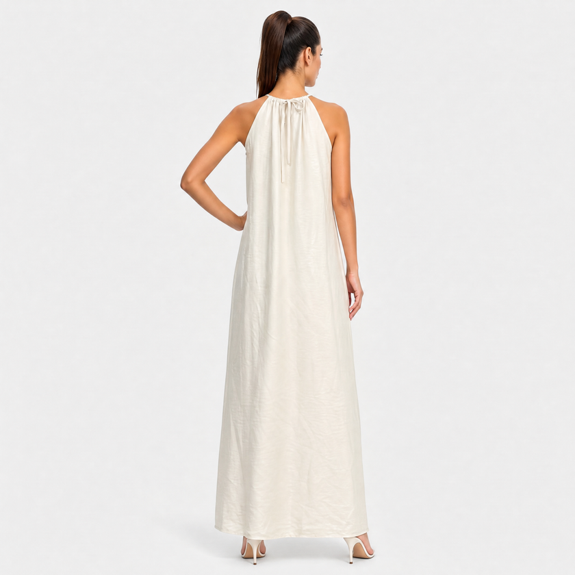 FJØRNA women's sleeveless halter neck summer maxi dress with flowing fabric and vibrant pattern, perfect for warm weather.