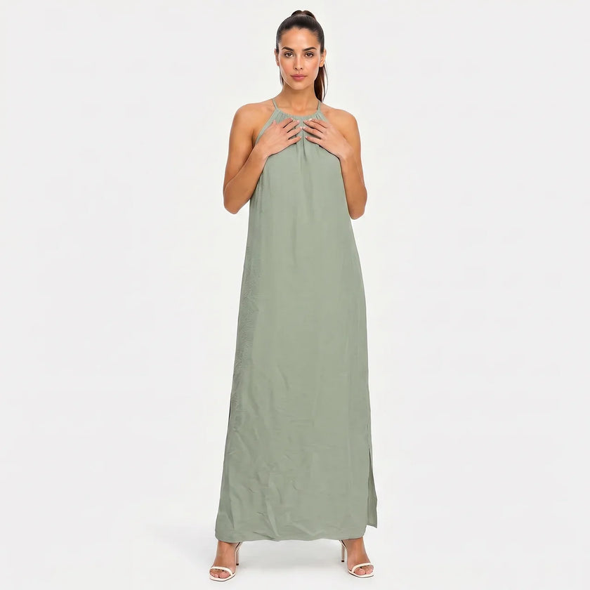 FJØRNA women's sleeveless halter neck summer maxi dress with flowing fabric and vibrant floral pattern.