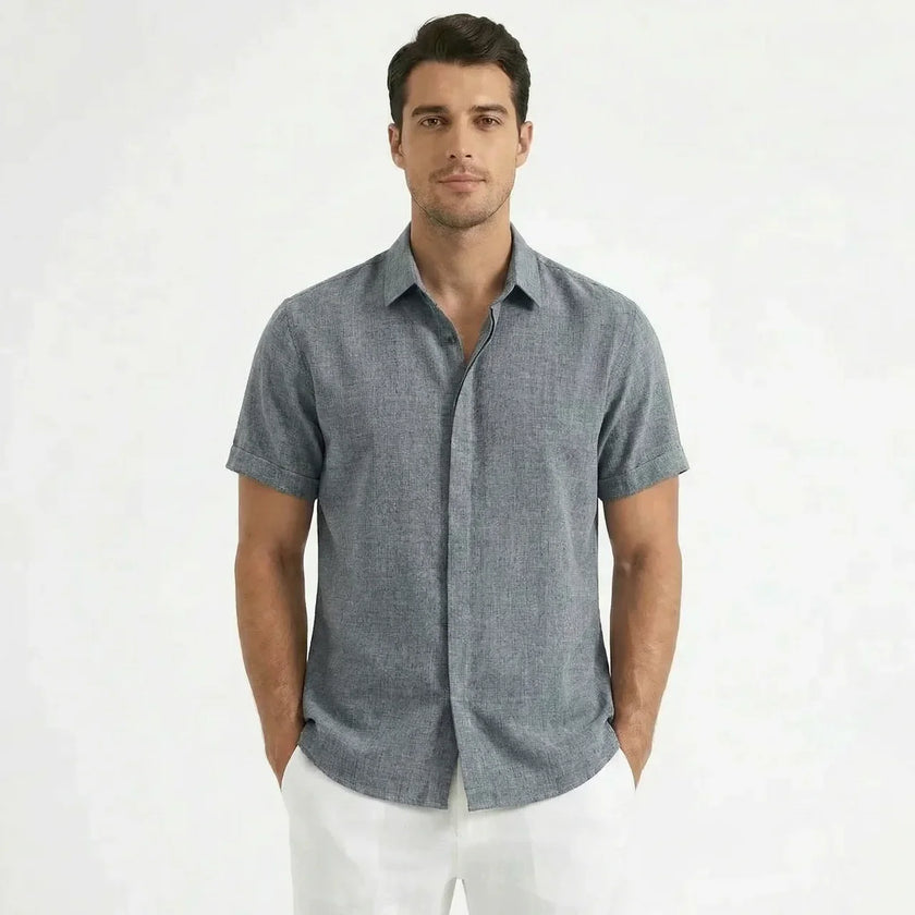 Men's FJØRNA cotton-linen short sleeve shirt displayed on a hanger, featuring a casual design with a button-up front and collar.