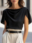 Black satin women's blouse with cap sleeves and draped design by FJØRNA, shown on a model.
