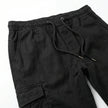 Men's slim fit cotton cargo trousers by FJØRNA, showcasing the relaxed fit, multiple cargo pockets, and classic khaki color.