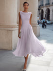 FJØRNA sleeveless pleated midi dress with draped neckline, flowing fabric, and elegant design perfect for stylish occasions.