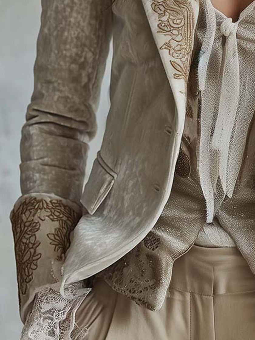 Ivory velvet blazer with intricate embroidery and lace cuffs, long sleeve style by FJØRNA, shown on a model.