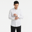 Men's FJØRNA long sleeve linen button-down shirt in a light-colored fabric with a classic collar and button cuffs.