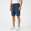 Men's summer linen shorts by FJØRNA, light and breathable fabric, displayed in a casual fit on a model.