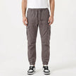 Men's slim fit cotton cargo trousers by FJØRNA, featuring multiple cargo pockets and a tailored fit in a neutral color.