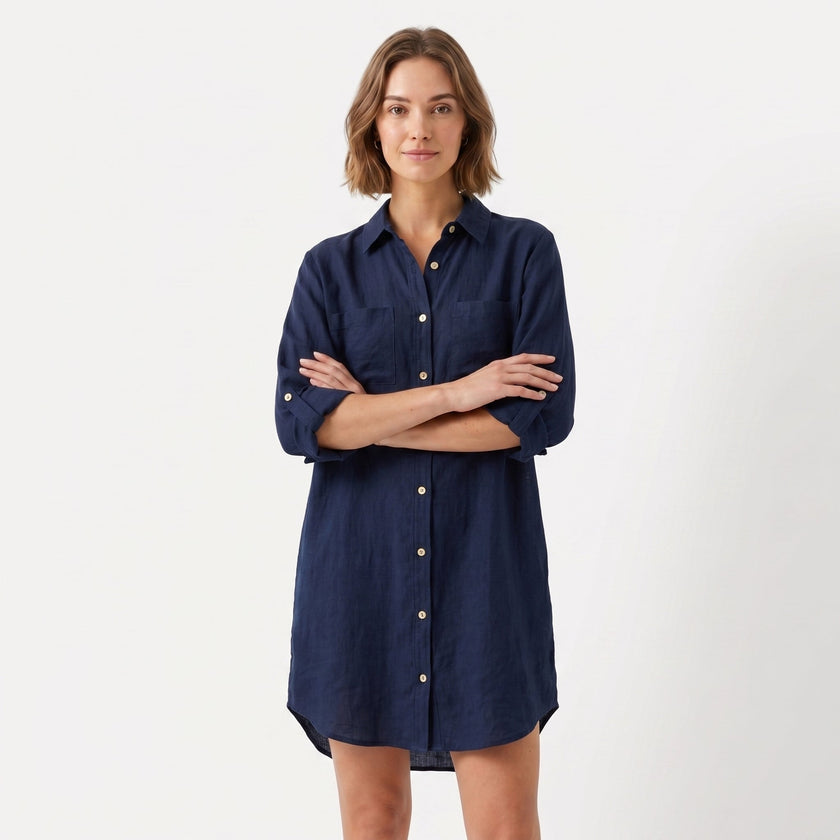 Women's oversized linen shirt dress by FJØRNA, featuring a relaxed fit, button-down front, and casual style, shown on a model.
