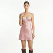 FJØRNA women's satin lace slip mini dress featuring delicate lace details and a smooth satin fabric on a model.
