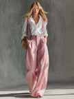 Pink cotton linen wide-leg dungarees for women by FJØRNA, featuring relaxed fit overalls with adjustable straps and side pockets.