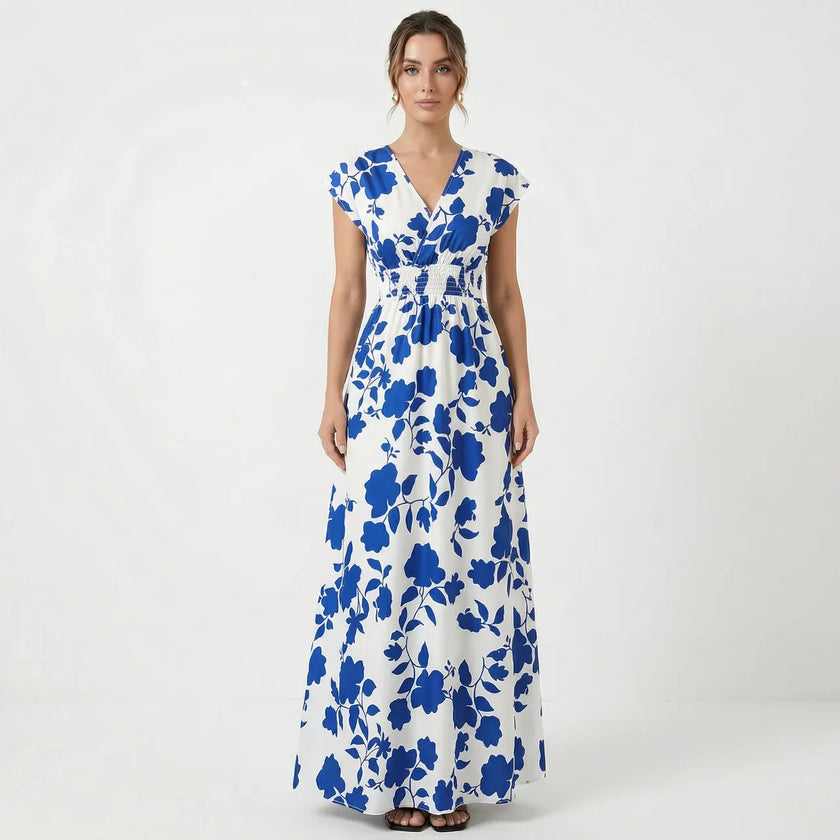Women's V-neck floral print summer maxi dress by FJØRNA featuring a flowing design and vibrant floral pattern.