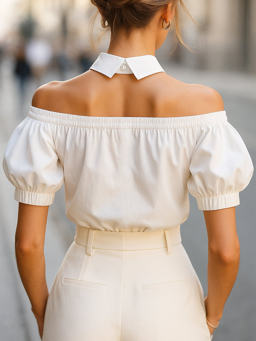 White FJØRNA women's off-shoulder blouse with puff sleeves, button-up front, and statement collar, stylish and elegant.