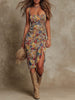 FJØRNA ruched midi floral dress with a casual style, featuring a fitted bodice and flowing skirt with colorful floral pattern.