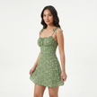 Women's floral print tie strap mini dress by FJØRNA, featuring a feminine design with colorful floral patterns and a stylish fit.
