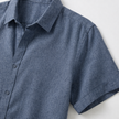 Men's cotton-linen short sleeve shirt by FJØRNA, light fabric with a button-up front and classic collar, worn casually.