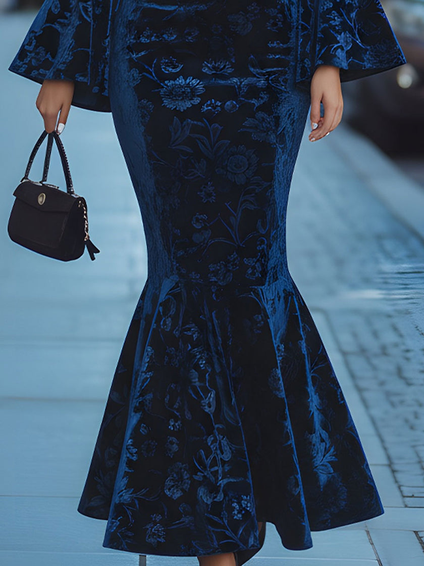 Royal blue floral velvet mermaid maxi dress by FJØRNA, showcasing a fitted silhouette with floral pattern and elegant design.