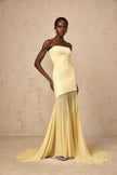 FJØRNA Josiane yellow off-shoulder sheer tulle maxi dress displayed on a hanger, showcasing its flowing fabric and elegant design.