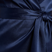 FJØRNA satin halter neck wrap maxi dress with bow tie waist and ruffled hem, elegant evening wear visible in the image.
