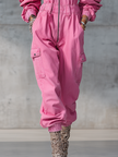 Pink denim strappy tapered long sleeve jumpsuit by FJØRNA, featuring a fitted silhouette and stylish design, shown on a model.