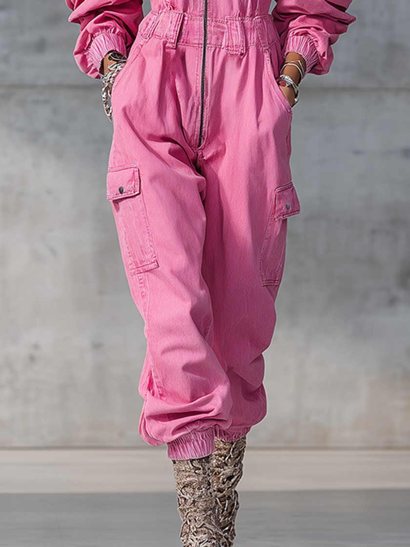 Pink denim strappy tapered long sleeve jumpsuit by FJØRNA, featuring a fitted silhouette and stylish design, shown on a model.